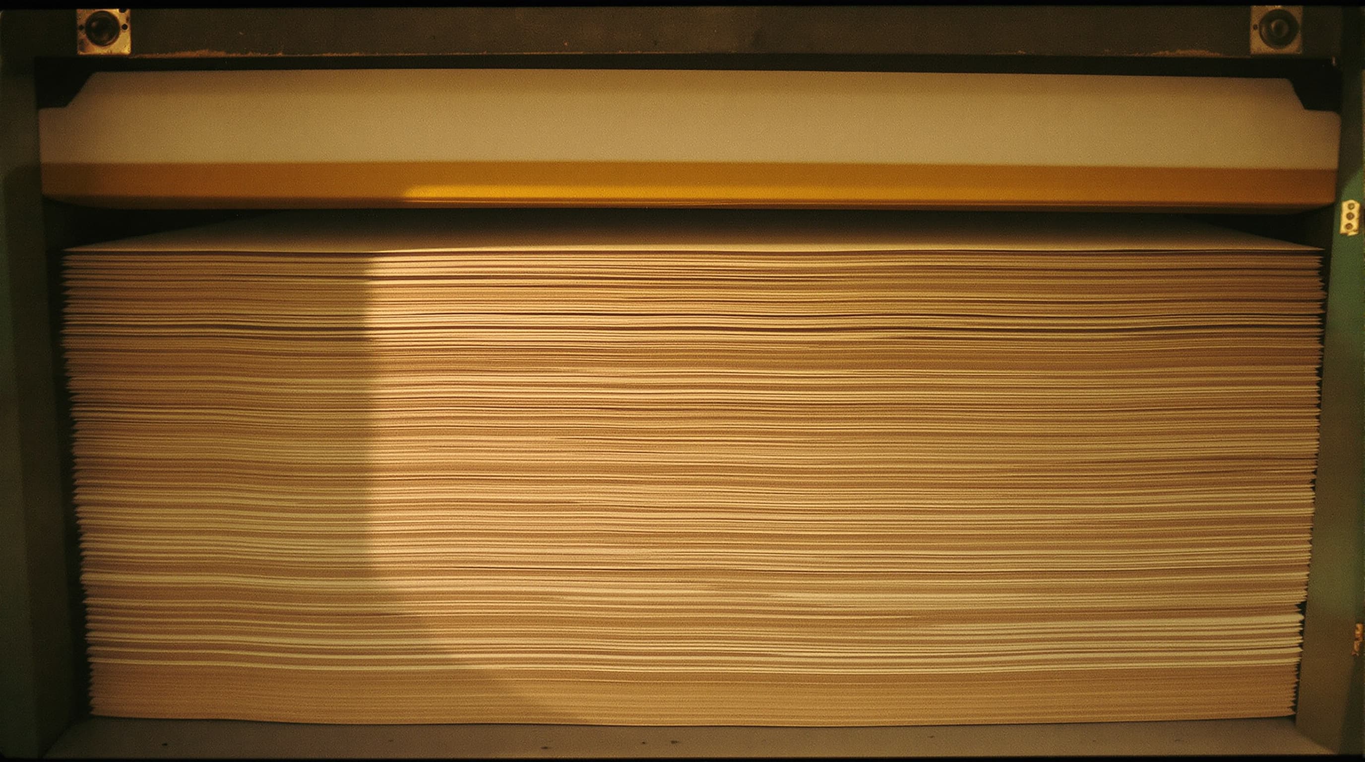 Stacked finished hemp paper sheets with deckle edges visible