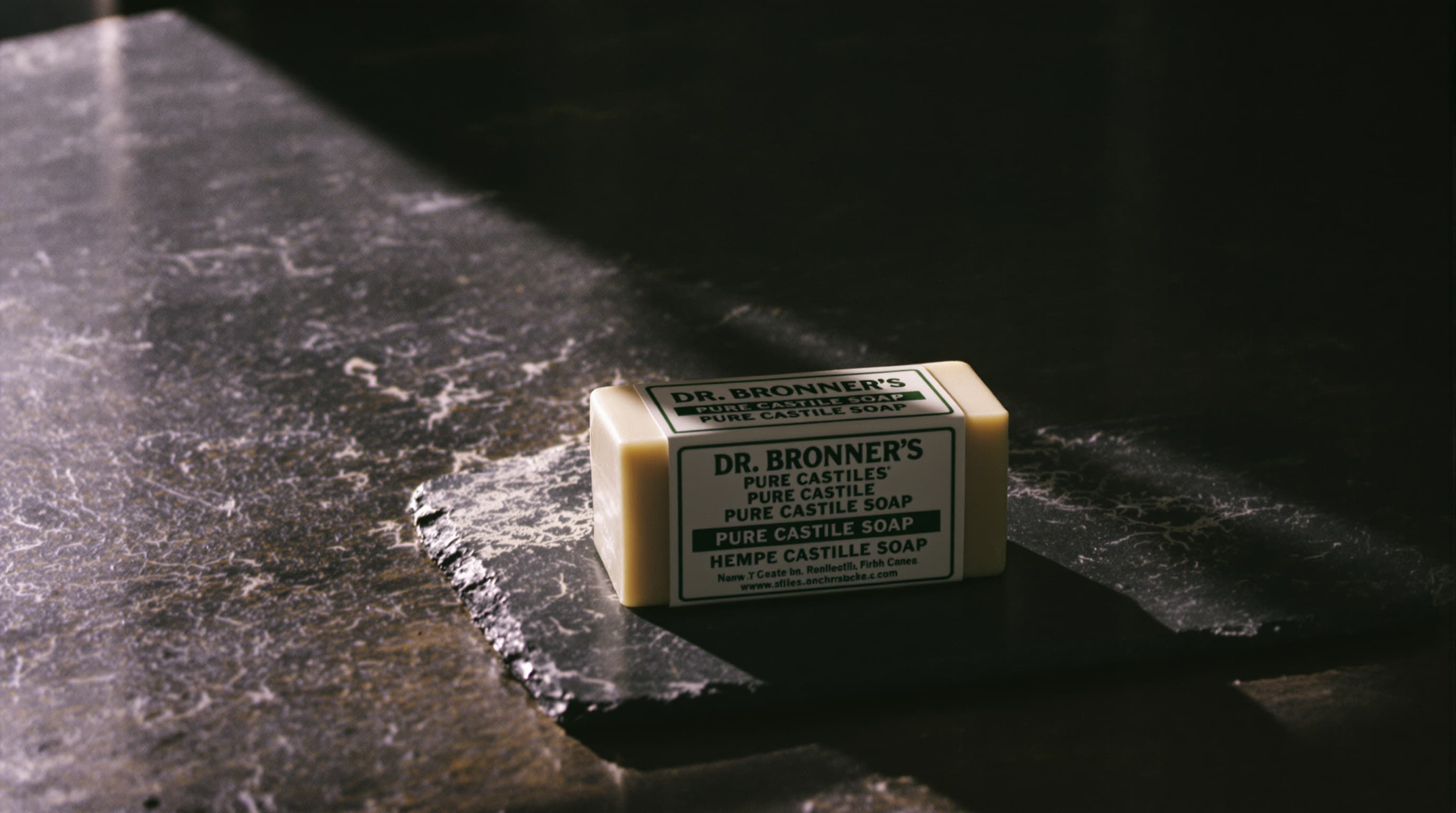 Stack of Dr. Bronner's hemp soap bars on slate
